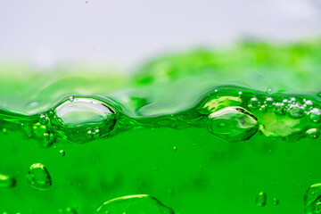 Water wave, close up of vibrant green liquid with bubbles, capturing dynamic movement and...