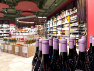 defocused alcohol (wine, champagne, liquor, whiskey) on store shelves