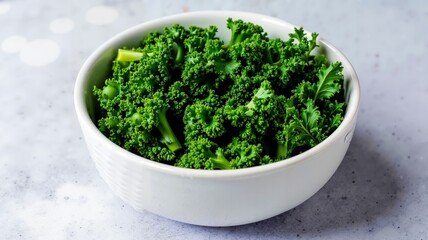 A white bowl filled with green vegetables on top of a table