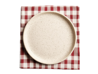 Rustic dining setup with speckled plate on checkered napkin, cut out