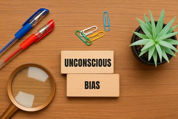 Unconscious Bias Concept Wooden Blocks Flatlay Image Top View Office Desk Workplace Magnifying Glass Pens Plant Business Psychology Cognitive Science Research Study Analysis Understanding Implicit    