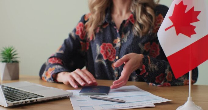 Canadian woman consular officer giving passport to male immigrant, work visa, citizenship. Visa Application online form immigration concept. Visa approval.