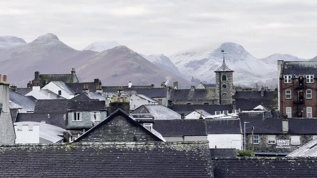 Idyllic view over Keswick town with snow-brushed fells in the background on a winter's morning - Lake District, UK