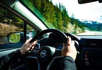 Driving the car. Hands on steering wheel
