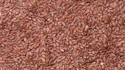 Brown flax seed or linseed on wooden background. Diet healthcare healthy food.