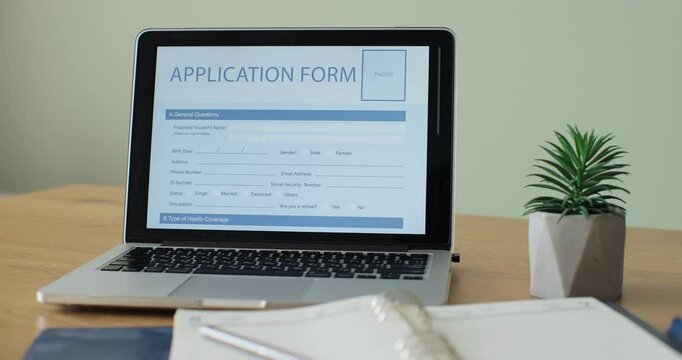 Laptop computer with an Application Form on its display.