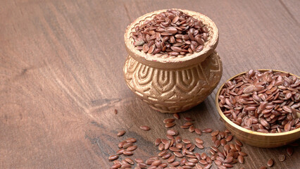 Brown flax seed or linseed on wooden background. Diet healthcare healthy food.