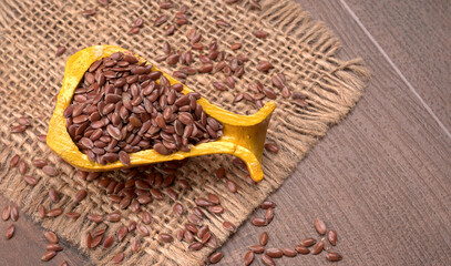 Brown flax seed or linseed on wooden background. Diet healthcare healthy food.