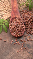 Brown flax seed or linseed on wooden background. Diet healthcare healthy food.