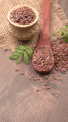 Brown flax seed or linseed on wooden background. Diet healthcare healthy food.