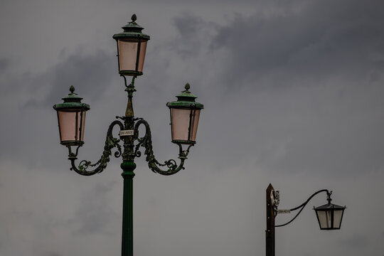 Classic Venetian Streetlight with Four Lamps and Clouds