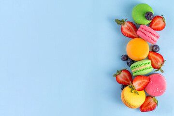 Bright and colorful sweet macaroons  dessert with fresh berries