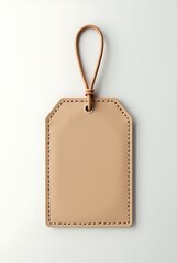 Empty tan leather blank gift tag or luggage label with string and copy space. Mockup view on white background for holiday and shopping concept.
