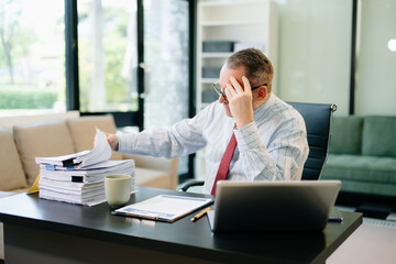 Professional businessman working at office with laptop, tablet, and notes. Perfect for business, finance