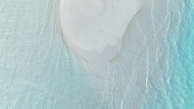 Summer lagoon Ripples in the sand at low tide on a beach with sandbar and blue sea in Maldives island
