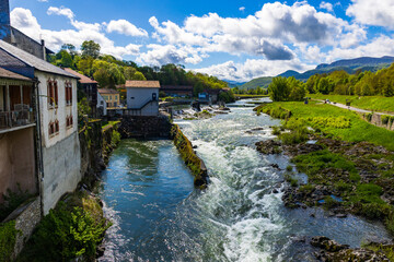 Fototapeta premium Salat River in front of the green mountains of the Couserans in spring from Saint-Lizier