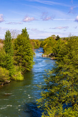 Fototapeta premium Salat River in front of the green mountains of the Couserans in spring from Saint-Lizier