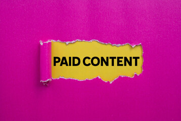 Paid content message written on ripped torn pink paper on yellow background. Conceptual paid content symbol. Copy space.