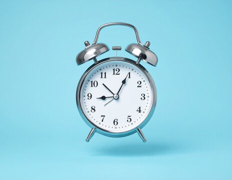 Vintage style silver alarm clock flying on blue background