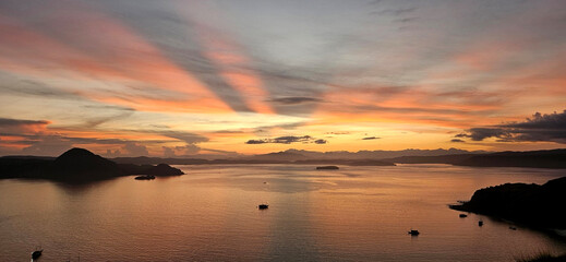Beautiful sun ray from the sunrise at the Padar island with ocean and island silhouette