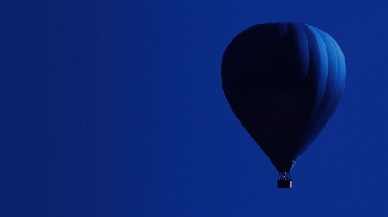 blue hot air balloon soaring in a deep blue sky