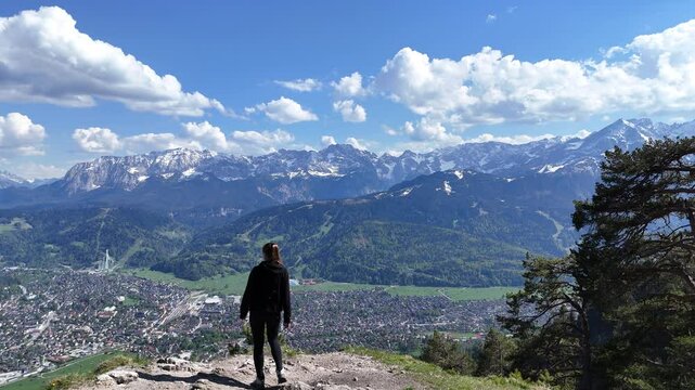 Woman Reaches Mountain Summit Above Garmisch, Aerial Drone Reveal of Spring Valley