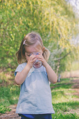 little girl drinking water from a glass