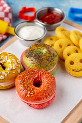 Mini bagels with salami, cheese and prosciutto served with fries, ketchup and mayonnaise