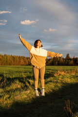 Millennial content creator basking in sunset light, where self-care, social presence, and nature-based calm intersect