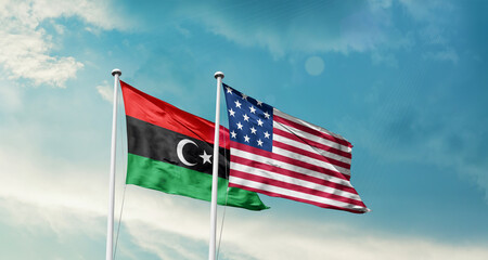 Libya and America friendship flags are waving in the sky.Two country flag for agreement or deal. Libya USA national flag for comittment.