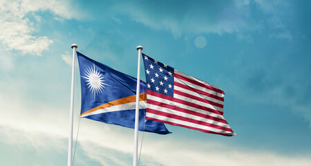 Marshall Islands and America friendship flags are waving in the sky.Two country flag for agreement...