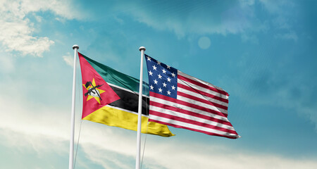 Mozambique and America friendship flags are waving in the sky.Two country flag for agreement or...