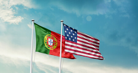 Portugal and America friendship flags are waving in the sky.Two country flag for agreement or deal....