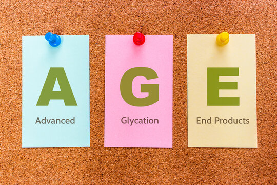 Conceptual 3 letters keyword AGE (Advanced Glycation End Products), on multicolored stickers attached to a cork board.