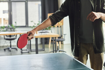 Engaging in a spirited table tennis match during a productive workday in the office space