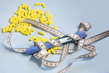  Ozempic syringe pen and measuring tape with a bunch of pills in the background