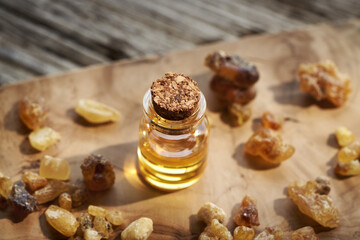 A bottle of frankincense essential oil with frankincense resin
