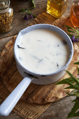 Preparation of comfrey root ointment using rendered pork lard in a saucepan