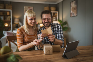 couple woman and man open presents gift during video call online
