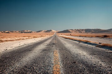 Fototapeta premium A never-ending road through a desert with a beautiful blue sky. Generative Ai