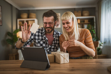 couple woman and man open presents gift during video call online
