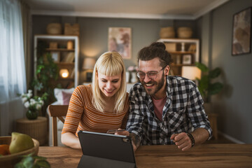 adult happy couple man and woman shopping online hold credit card