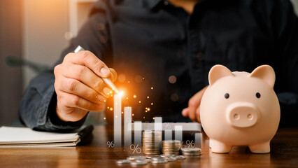 Concepts of saving money and financial planning. Man hand holding piggy bank on wood table, income, return, retirement, compensation fund, investment, dividend tax, stock market