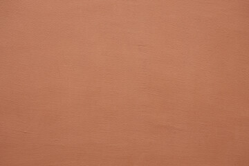 Coral stucco wall texture, peach fuzz color background. Abstract grunge artistic backdrop for...