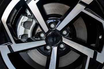 Car wheel with brake calipers and stylish design.