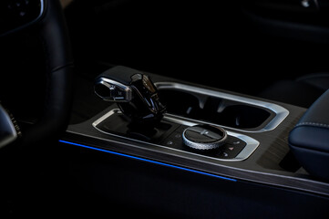 Automatic transmission selector in the interior of a modern car.