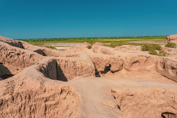 A desert landscape with a large hole in the ground