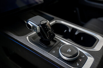 Automatic transmission selector in the interior of a modern car.
