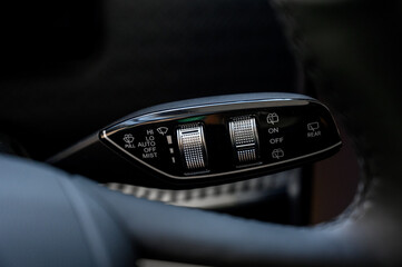 Close up view of car light switch control. Headlight switch, turn signal lever