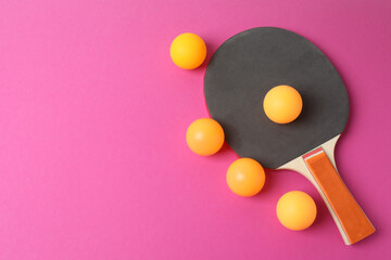 Ping pong racket with the ball for playing table tennis on a colored background